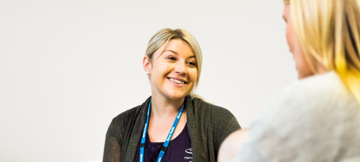 Woman smiling at another woman